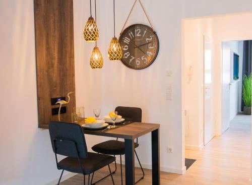 a dining room with a table and a clock on the wall at Home in Dahme