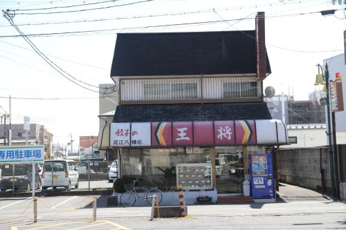 a building on a street next to a street at Stay Omihachiman Ekimae Inn in Omihachiman