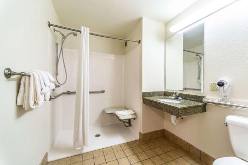 a bathroom with a toilet and a sink at Welcome Suites-O'Fallon in O'Fallon