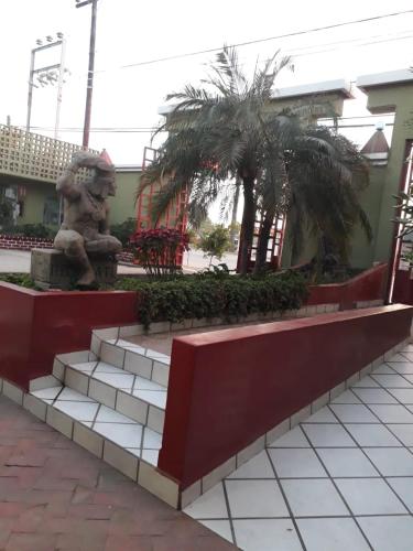 a park with a statue and trees in a building at HOTEL AZTECA INN in Ensenada