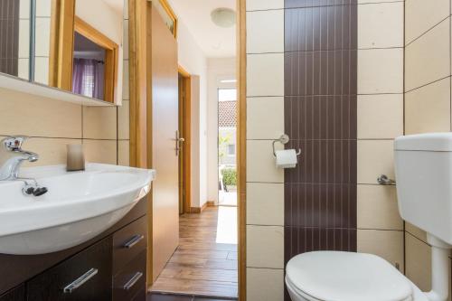 a bathroom with a sink and a toilet at Apartments Tomas in Dubrovnik