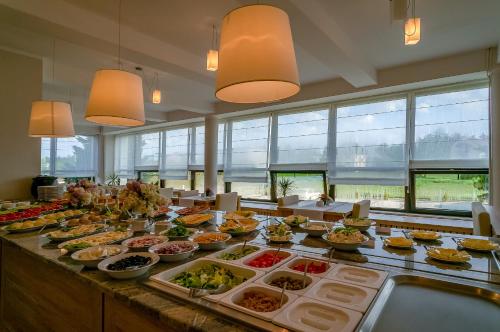 a buffet line with many different types of food at Hotel *** NAT Jarosławiec in Jarosławiec