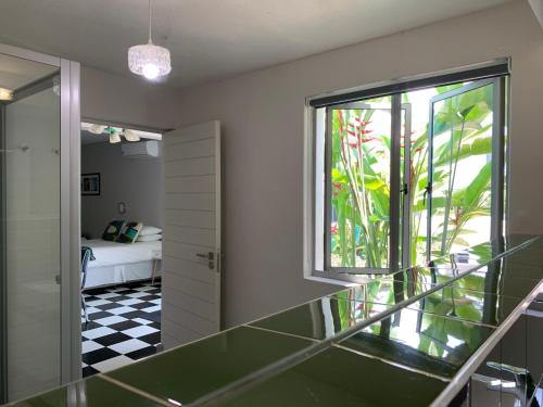 a bathroom with a glass counter and a window at HP Twelve Accommodation in Nelspruit