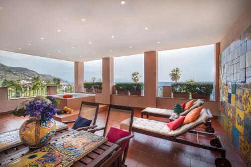 a living room with a view of the ocean at Hotel Caparena in Taormina