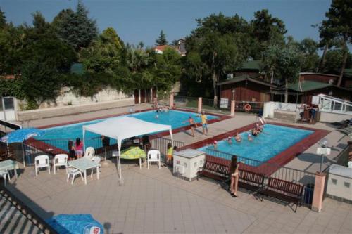 a large swimming pool with people standing around it at La Pineta in Albenga