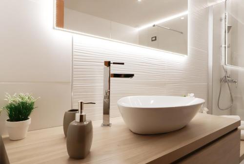 a bathroom with a large white bowl sink on a counter at Pegasus Hotel in Sassari