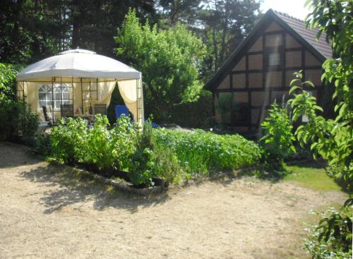 a gazebo in the yard of a house at Ferienhaus Bildt in Kolpinsee