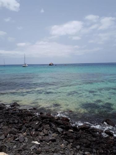 a view of the ocean with two boats in the water at Ático Sun&Beach Fuerteventura in Gran Tarajal