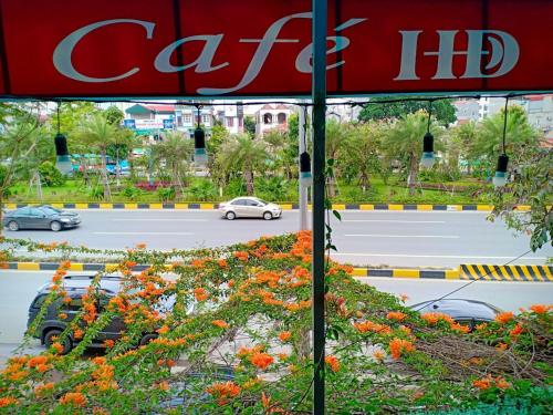 a red umbrella in front of a street with cars at HD Hotel Nội Bài in Noi Bai