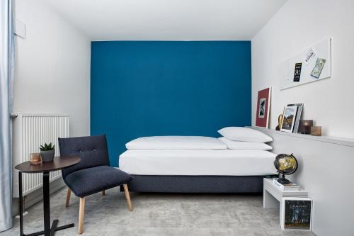 Ένα ή περισσότερα κρεβάτια σε δωμάτιο στο H.ome Serviced Apartments München