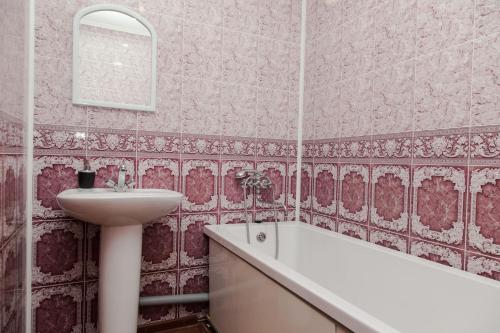 a bathroom with a sink and a bath tub at Apartment on Kukolkina in Voronezh
