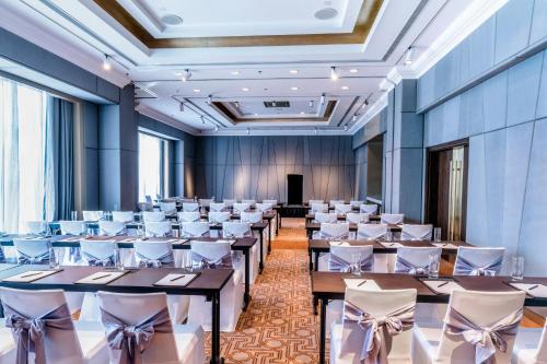 a large banquet hall with tables and chairs at Caravelle Saigon in Ho Chi Minh City