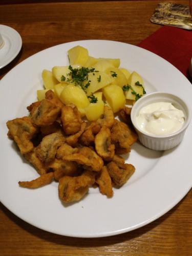 a plate of food with potatoes and a bowl of dip at Hotel Zámeček Pod Hradem Starý Jičín 111 in Starý Jičín