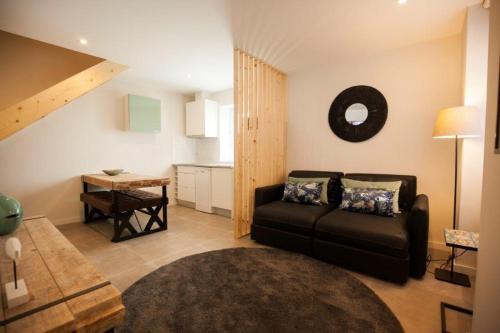 a living room with a couch and a table at OportoWaves in Matosinhos
