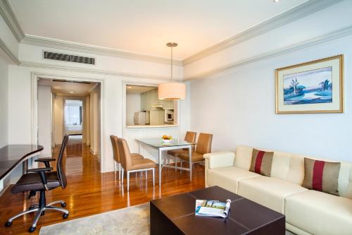 a living room with a couch and a table at Wyndham Casablanca Jakarta in Jakarta