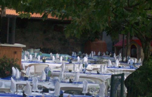 a group of tables with blue and white table cloths at La Foce Del Prato in Framura