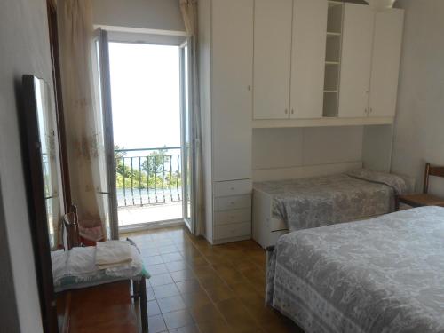 a room with two beds and a large window at La Foce Del Prato in Framura