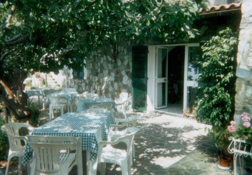 a table and chairs sitting in front of a building at La Foce Del Prato in Framura