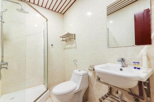 a bathroom with a toilet and a sink and a shower at Beautat Hotel in Abha