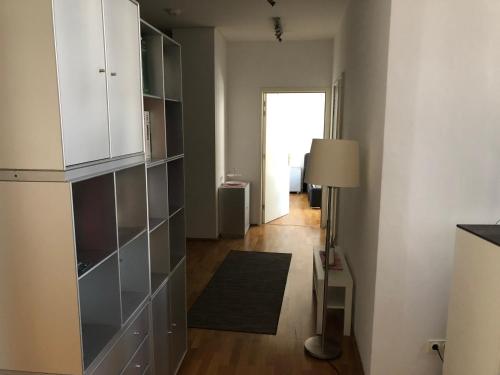 a living room with a large white cabinet and a hallway at Ferienwohnung mitten in Wiesbaden in Wiesbaden