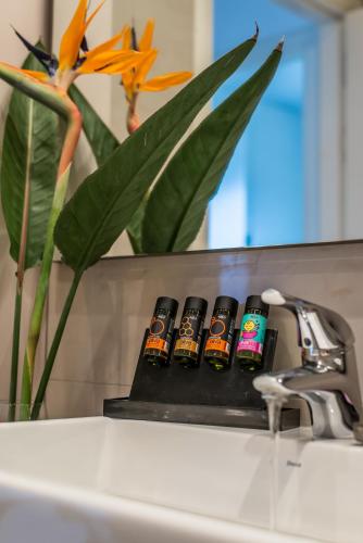 a group of four bottles of beer sitting next to a sink at Lavender Villas Chania in Agia Marina Nea Kydonias