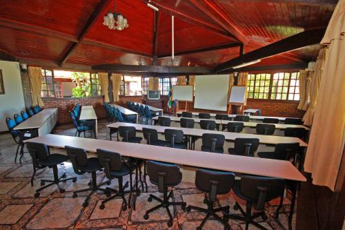 a large room with tables and chairs in it at Pousada do Marujo in Rio das Ostras