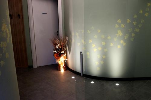 a room with a wall with yellow stars on the wall at Hotel Adler in Foppolo