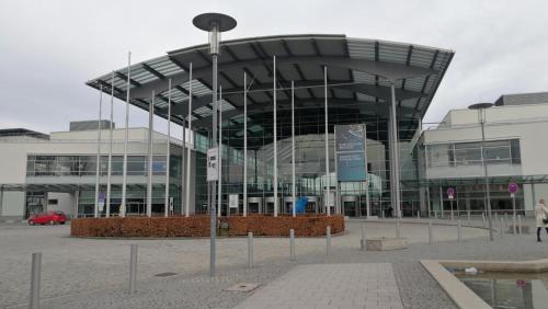 a large building with a lot of glass at Myroom Business Apartment Nähe Messe München in Munich