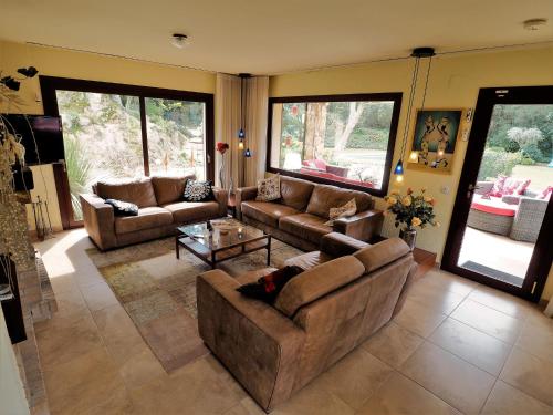 a large living room with couches and a table at Belvilla by OYO Vall Repos in Calonge