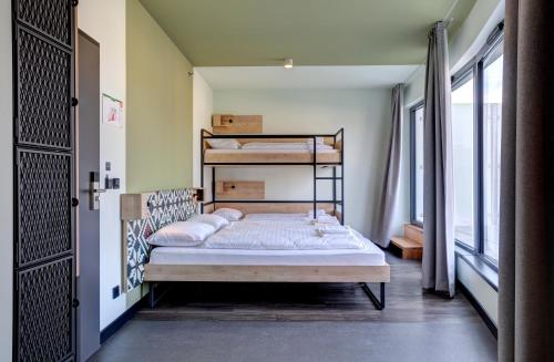 a bedroom with two bunk beds in a room at MEININGER Budapest Great Market Hall in Budapest