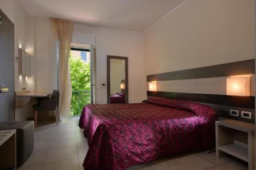 Postel nebo postele na pokoji v ubytování Hotel Siena