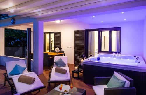 a bathroom with a tub with chairs and a table at Apartment Auretta in Novigrad Istria