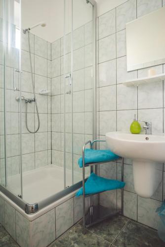 a bathroom with a shower and a sink and a tub at Paradise in Charzykowy