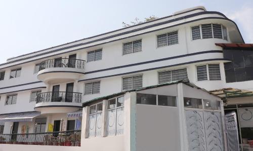 a white building with a lot of windows at Treebo Trend Mayur - Mall Road in Mussoorie