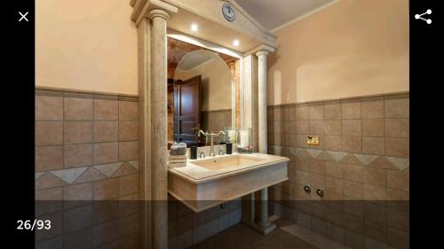 a bathroom with a sink and a large mirror at AltaVista - Perugia in Perugia