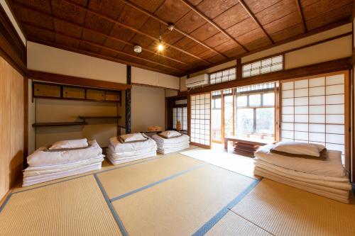 a room with four bunk beds in a room at Yuzan Guesthouse in Nara
