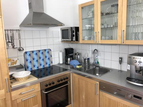 a kitchen with a sink and a stove top oven at Ferienwohnung Kronegarten in Gmunden