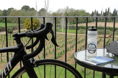 a bike parked next to a table with a bottle at Finca Agroturismo Son Menut in Felanitx