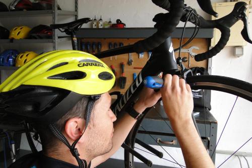 a man in a helmet working on a bike at Finca Agroturismo Son Menut in Felanitx