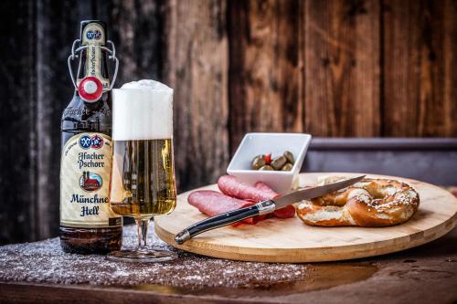 a table with a bottle of beer and a glass at Ferienhaus Butterfly in Garmisch-Partenkirchen