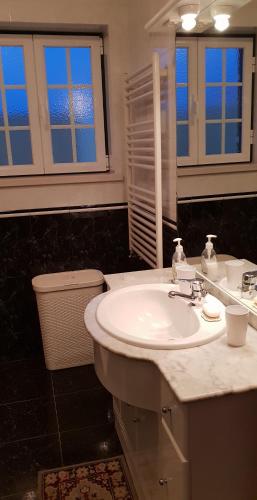 a bathroom with a white sink and a mirror at Casa Harmonica com vista mar in Areia Branca