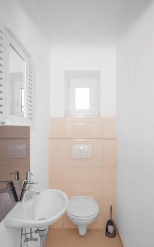 a bathroom with a white sink and a toilet at Ferienhaus Butterfly in Garmisch-Partenkirchen