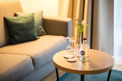 a living room with a couch and a table at HELDs Vitalhotel in Ruhpolding