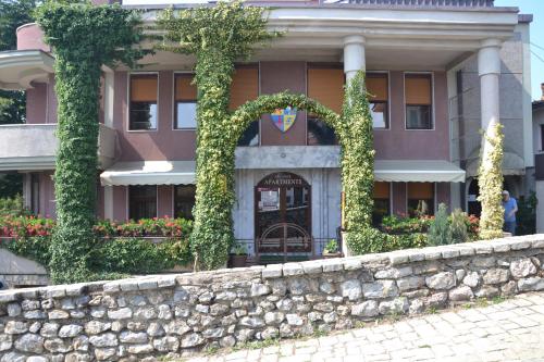 a building with a stone wall in front of it at Villa Forum in Ohrid