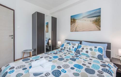 a bedroom with a bed with blue and white pillows at Apartments Kimi in Rovinj
