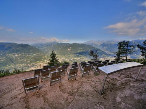 a row of chairs sitting on top of a mountain at Hotel Restaurant Alber in Verano