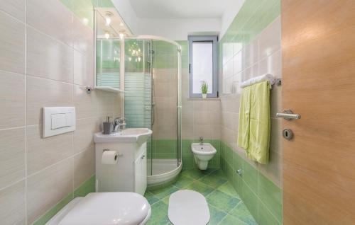 a bathroom with a toilet and a sink and a shower at Apartments Kimi in Rovinj