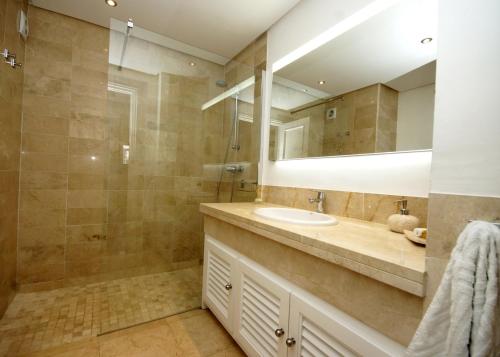 a bathroom with a sink and a shower at Jardines de las Golondrinas Marbella with Sea Views in Marbella