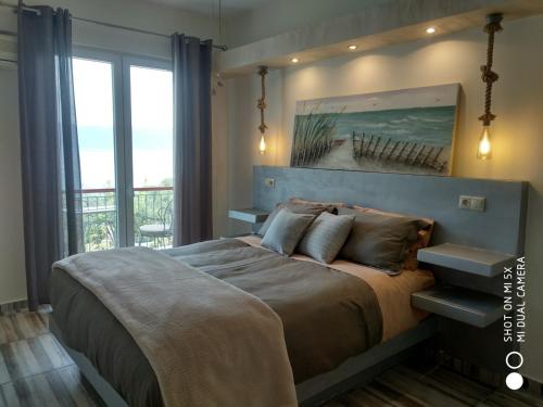 um quarto com uma cama e vista para o oceano em Waterside Apartments em Agia Effimia