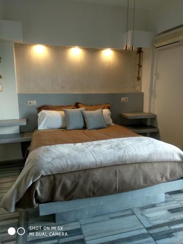 a bedroom with a large bed with two pillows at Waterside Apartments in Ayia Evfimia
